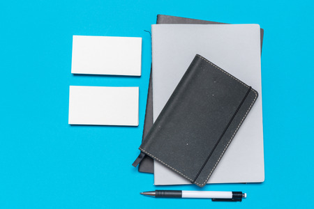 Blank paper notebook on blue background.Office desk table concept.の写真素材