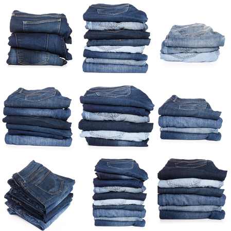 Collection of folded jeans isolated on white backgroundの写真素材