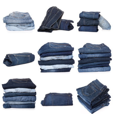 Collection of folded jeans isolated on white backgroundの写真素材