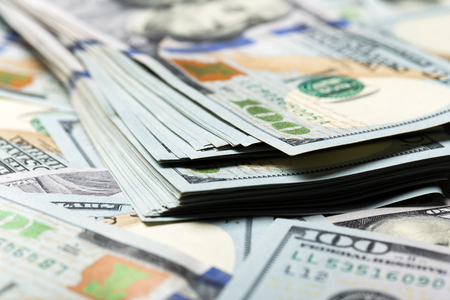 American dollars. A stack of hundred dollar bills. Close up of new hundred dollar bill on the white background.の写真素材