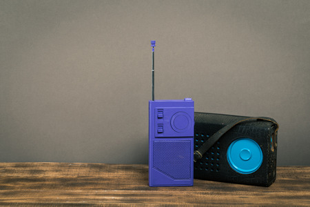 Vintage old radio on wooden table with color wall backgroundの写真素材