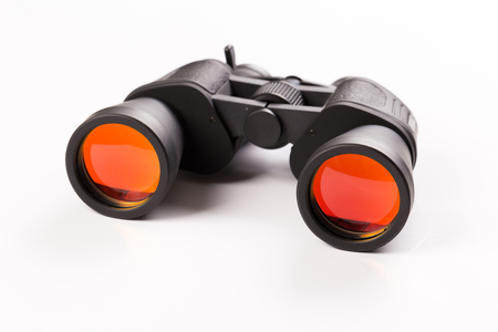 Black binoculars with orange lens isolated on white backgroundの写真素材