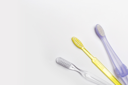 New different colored toothbrushes on a white backgroundの写真素材