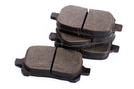 Set of old brake pads, car spares isolated on white backgroundの写真素材