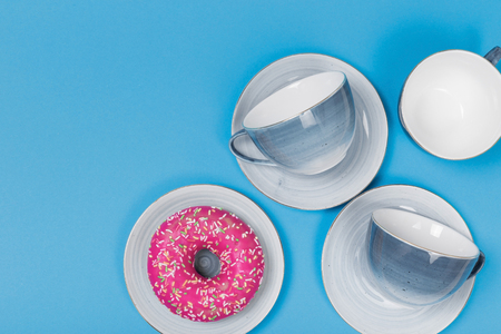 Empty plates and bowls on blue wooden background. Retro toned. Top view with copy spaceの写真素材