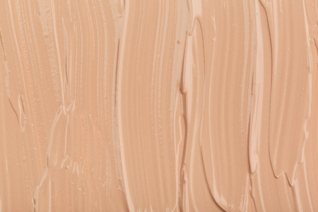 Close up of smear beige and ligth pink tone foundation texture for background.の写真素材