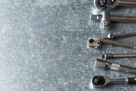 old wrench and tools and Engine spare parts on rusty backgroundの写真素材