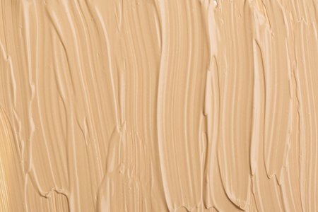 Close up of smear beige and ligth pink tone foundation texture for background.の写真素材