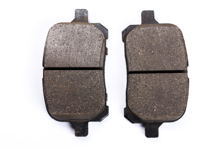 Set of old brake pads, car spares isolated on white backgroundの写真素材