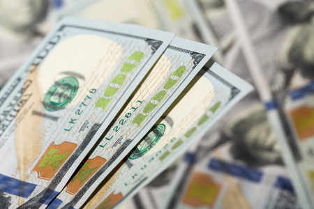 American dollars. A stack of hundred dollar bills. Close up of new hundred dollar bill on the white background.の写真素材