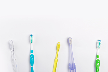 New different colored toothbrushes on a white backgroundの写真素材