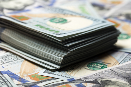 American dollars. A stack of hundred dollar bills. Close up of new hundred dollar bill on the white background.の写真素材