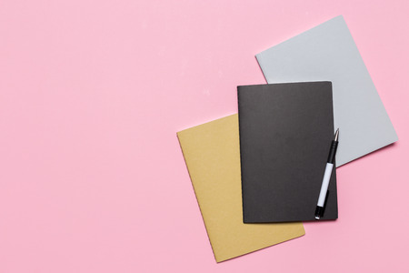 school notebook on a pink background, notepad on a table.Top viewの写真素材