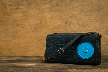 Vintage old radio on wooden table with color wall backgroundの写真素材