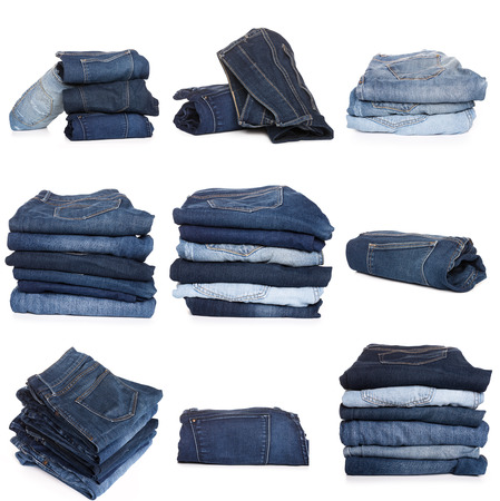 Collection of folded jeans isolated on white backgroundの写真素材
