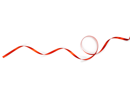 Red satin ribbon isolated on white backgroungの写真素材