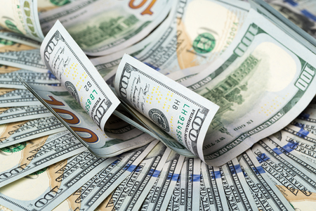 American dollars. A stack of hundred dollar bills. Close up of new hundred dollar bill on the white background.の写真素材