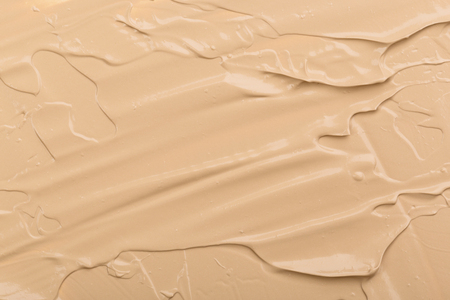 Close up of smear beige and ligth pink tone foundation texture for background.の写真素材