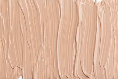 Close up of smear beige and ligth pink tone foundation texture for background.の写真素材