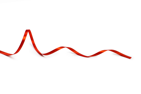 Red satin ribbon isolated on white backgroungの写真素材