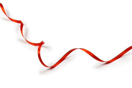 Red satin ribbon isolated on white backgroungの写真素材