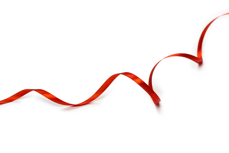 Red satin ribbon isolated on white backgroungの写真素材