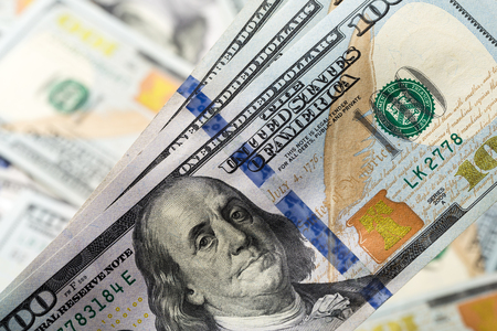 American dollars. A stack of hundred dollar bills. Close up of new hundred dollar bill on the white background.の写真素材
