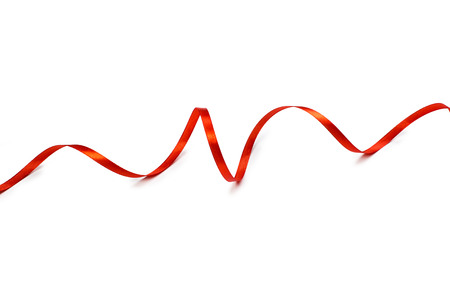 Red satin ribbon isolated on white backgroungの写真素材