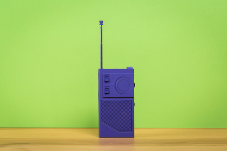 Vintage old radio on wooden table with color wall backgroundの写真素材