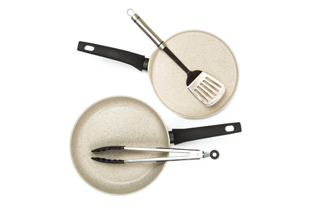 Photo of a bright ceramic pan with a black handle, isolated on a white background. Studio shotの写真素材