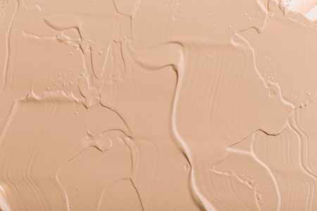 Close up of smear beige and ligth pink tone foundation texture for background.の写真素材