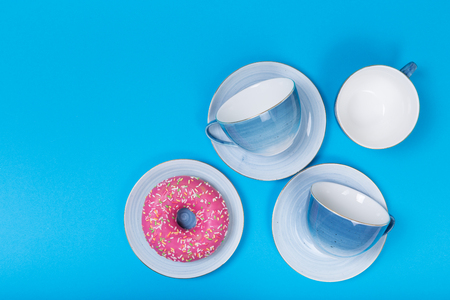 Empty plates and bowls on blue wooden background. Retro toned. Top view with copy spaceの写真素材