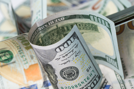American dollars. A stack of hundred dollar bills. Close up of new hundred dollar bill on the white background.の写真素材