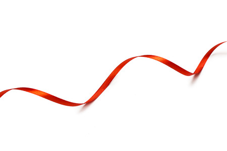Red satin ribbon isolated on white backgroungの写真素材