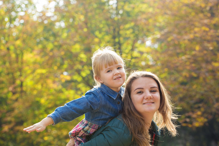 happy mother playing with his daughter in the park  in summer dayの写真素材