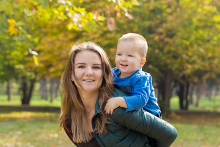 happy mother playing with her son in the park  in summer dayの写真素材