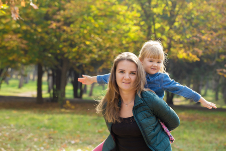 happy mother playing with his daughter in the park  in summer dayの写真素材