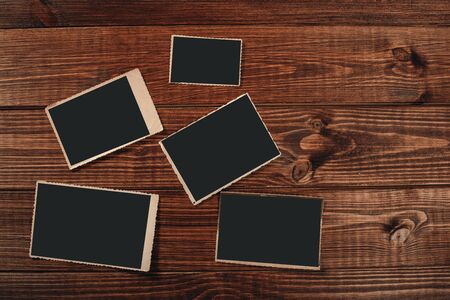 Stack old photos on table. Mock-up blank paper. Postcard rumpled and dirty vintage. Retro cardの写真素材