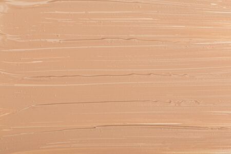 Close up of smear beige and ligth pink tone foundation texture for background.の写真素材