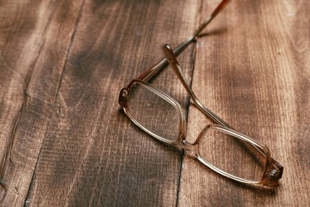 A pair of glasses on a wooden tableの写真素材