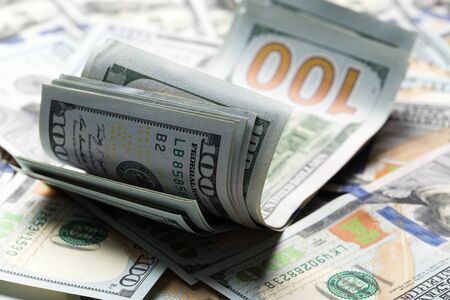 American dollars. A stack of hundred dollar bills. Close up of new hundred dollar bill on the white background.の写真素材