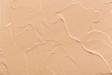 Close up of smear beige and ligth pink tone foundation texture for background.の写真素材