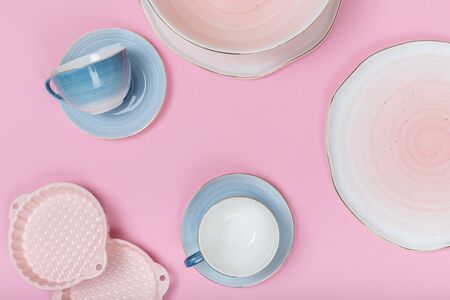 Empty plates and bowls on pink background. Top view with copy spaceの写真素材