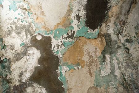 Brick wall. Old flaky white paint peeling off a grungy cracked wall. Cracks, scrapes, peeling old...