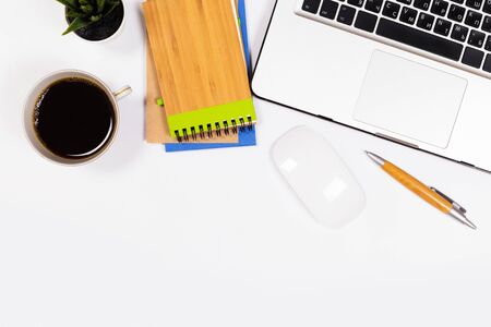Modern workspace with coffee cup, smartphone, paper, notebook, tablet and laptop copy space on white color background. Top view. Flat lay style.の写真素材