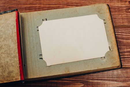 Stack old photos on table. Mock-up blank paper. Postcard rumpled and dirty vintage. Retro card