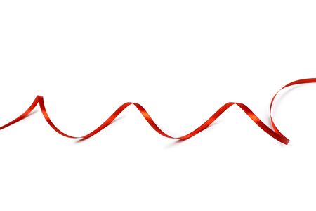 Red satin ribbon isolated on white backgroungの写真素材
