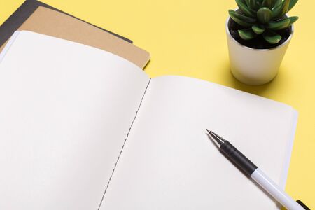 school notebook on a yellow background, notepad on a table.Top viewの写真素材