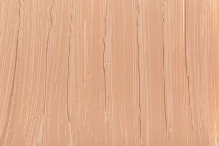 Close up of smear beige and ligth pink tone foundation texture for background.の写真素材