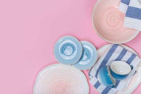 Empty plates and bowls on pink background. Top view with copy spaceの写真素材